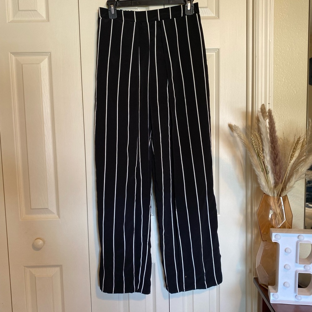 Black and white pin stripped pants with two slits up each leg